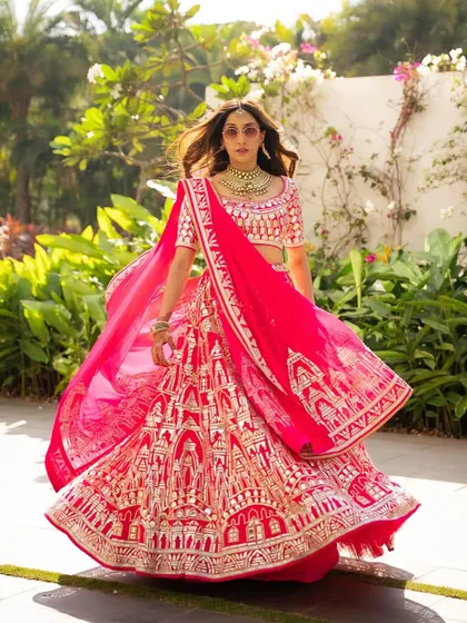 A stunning Mehendi celebration look for the sister-in-law. The vibrant pink Abu Sandeep lehenga called for a makeup look that was equally bold and beautiful, with defined eyes and a matching pink lip.