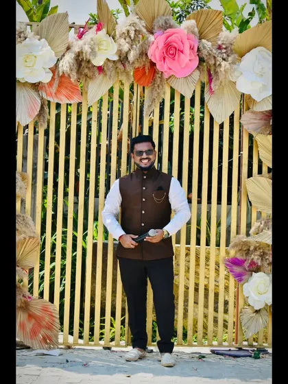 Another pose against a beautiful floral backdrop at a Haldi event.