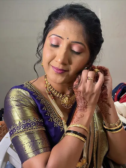 A candid moment of Rashmi getting ready. I focused on soft pink eyeshadow and a matching lip color to complement her beautiful blue and gold saree.