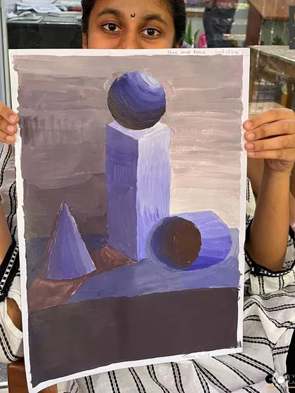 A student displays her monochrome study of geometric shapes. This fundamental exercise helps artists master shading and value scales using a single color.
