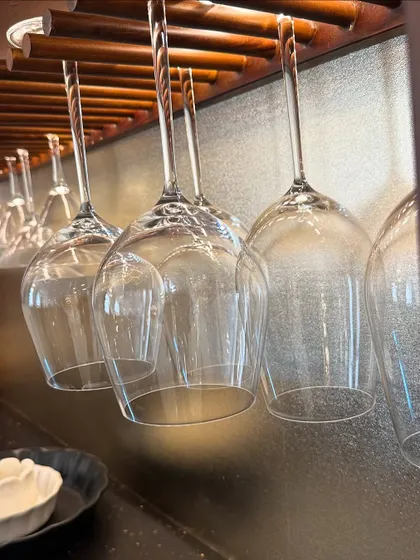 Another view of the hanging glass rack, showcasing its elegant and functional design. It keeps glassware organized while contributing to the sophisticated look of the bar.