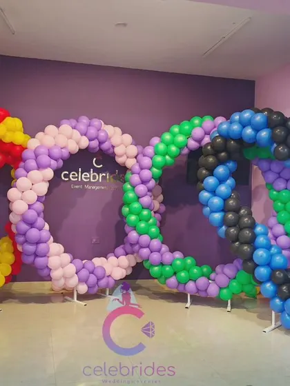 Students practicing basic balloon structures like these colorful heart-shaped rings during our decoration classes.