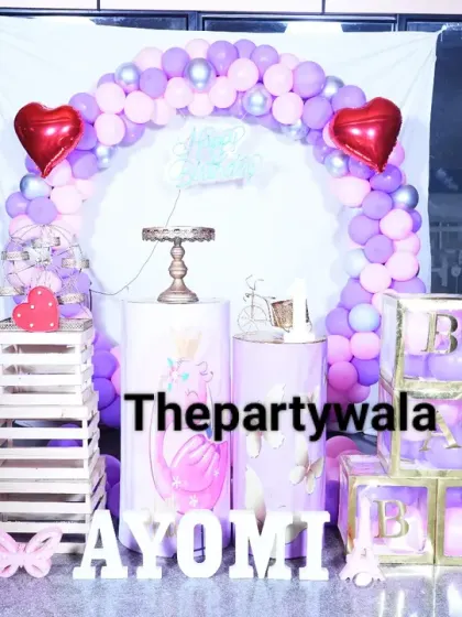 A lovely princess theme for a first birthday, featuring heart-shaped foil balloons and cutouts of Aurora and Cinderella.