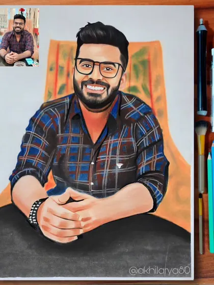 A cheerful portrait of a man in a plaid shirt, drawn on A4 paper. The colored pencils bring out his warm smile and the colors of the shirt.
