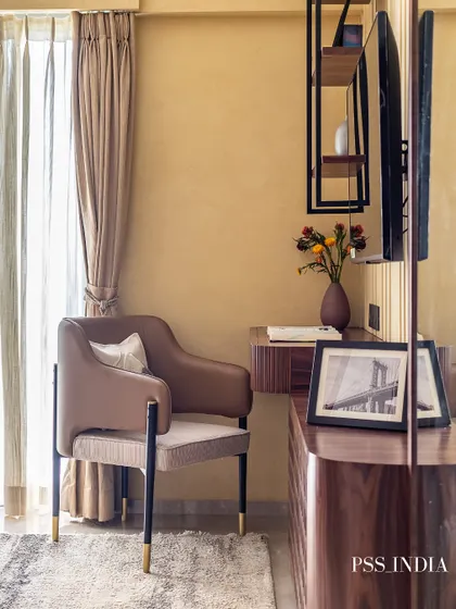 Another angle of the sophisticated study nook, highlighting the comfortable armchair and the natural light from the window, making it a pleasant place to work or read.