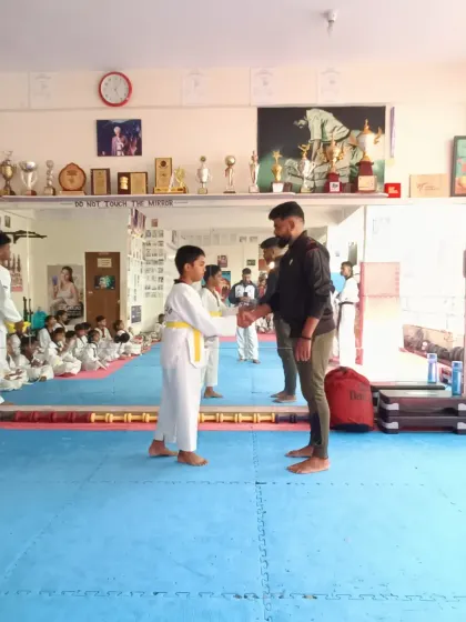 A student receives his yellow belt.