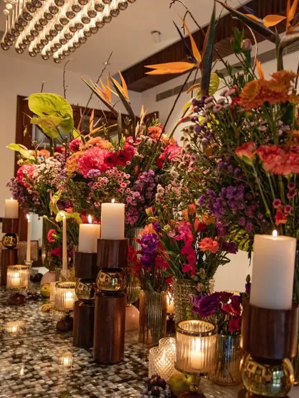Another angle of the 'Made in Heaven' inspired tablescape, showing the height and drama of the arrangements. The Birds of Paradise add a sculptural element to the lush composition.