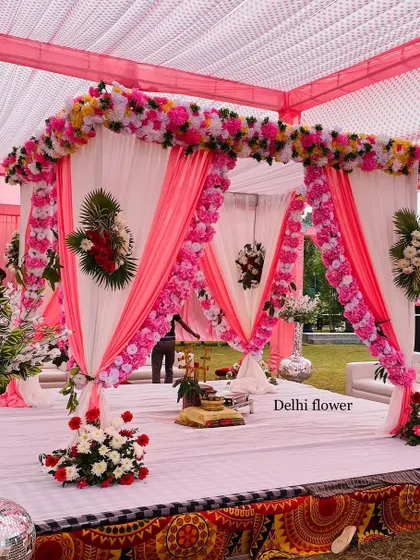 A beautiful pink and white themed mandap. The pillars are wrapped in flowers, and the draped fabric creates a soft, romantic look.
