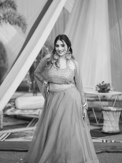 A classic black and white portrait in the lehenga. This adds a touch of timeless elegance to the wedding series.
