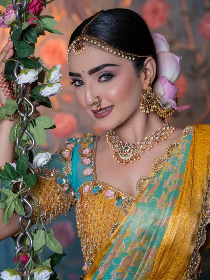 A close-up of the model, her makeup and hairstyle complementing the grand bridal look.
