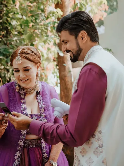 A modern twist on a memory. The groom shows the bride an instant polaroid picture, a charming and personal moment we were there to capture.