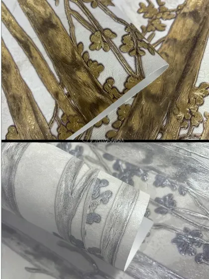 Close-up details of the texture and metallic finish on a gold and silver tree-patterned wallpaper.