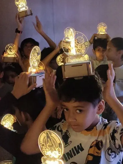 The lights go down and the creations glow. Kids are amazed to see their own handmade lamps light up the room.