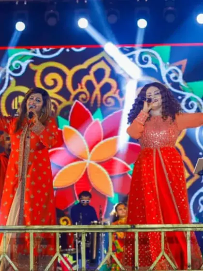 Arms wide open, embracing the energy of the crowd. This is what a live Navratri performance is all about.