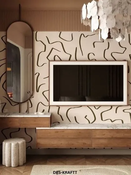 The entertainment and vanity wall in this bedroom is a work of art, with a bold, abstract wallpaper, a floating wood console, and an elegant oval mirror.