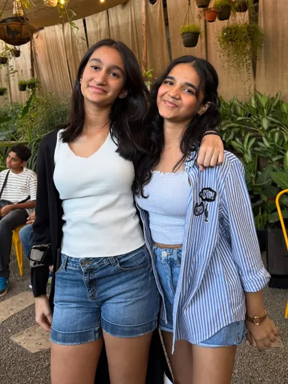 Two friends enjoying the vibe during our live music event. Our cafe is a great place to hang out and make new memories.