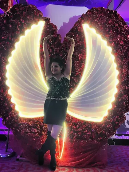 Spreading my wings at an event. I styled a black sequin top with a mini-skirt and knee-high boots for an edgy and glamorous party look.