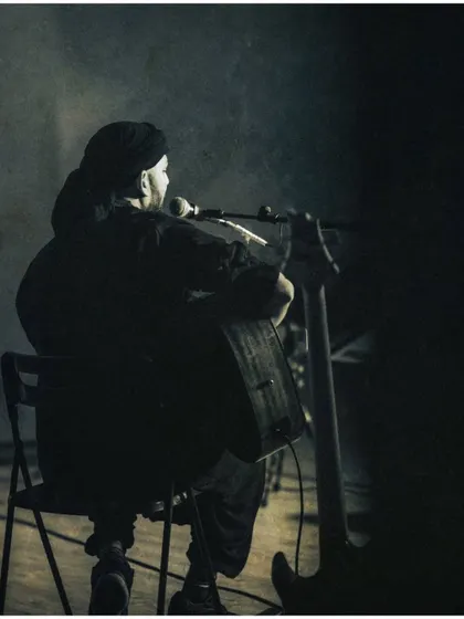 A quiet moment before the song begins. This photo, taken from behind, captures the anticipation and focus of a live performance.