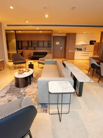 A dynamic low-angle shot that highlights the textures of the rug and the arrangement of modern furniture. This angle adds architectural interest and shows off the designer's choices.