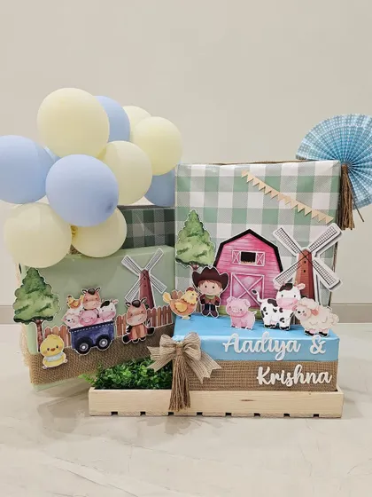 Bringing the cutest barnyard to life for a birthday celebration. This super adorable hamper, made for Aadiya and Krishna Piramal, features farm animal cutouts, gingham prints, and playful balloons.