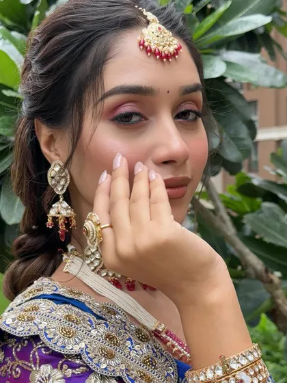 A close-up on the eye makeup, showing a beautiful blend of pink and brown shades that make the eyes pop.