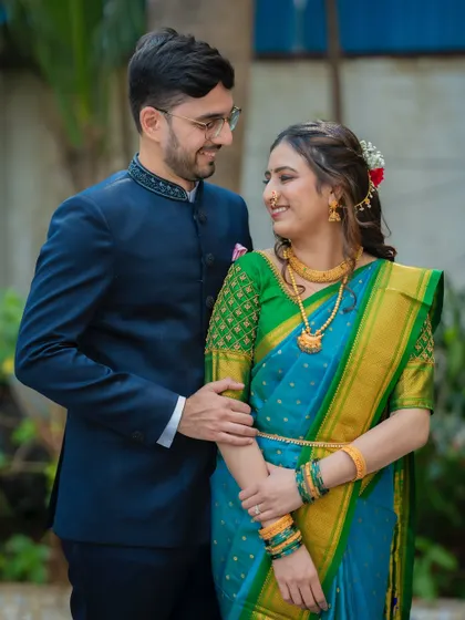 A beautiful three-quarter portrait of Ameya and Gautami, highlighting the details of her saree and his classic bandhgala jacket.