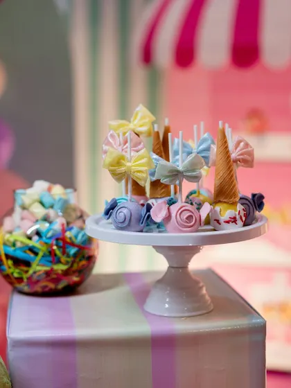 A close-up of the delightful dessert table, featuring custom sweets that are almost too pretty to eat.
