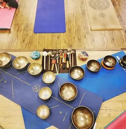 An arrangement of Tibetan singing bowls on yoga mats, set up by one of my graduates for her session. This shows the practical application of the skills learned in my course.