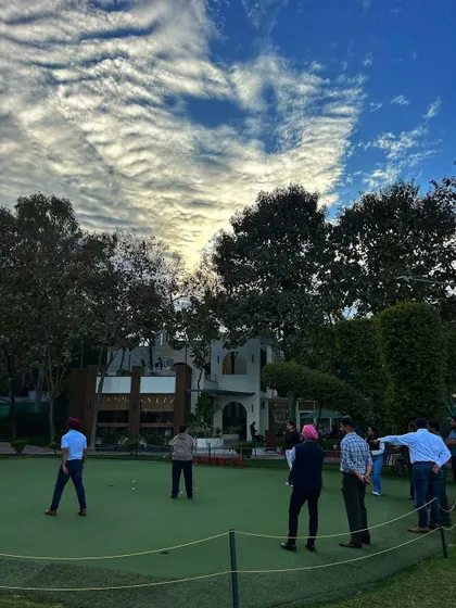 A group gathers on the putting green under a dramatic sky. It’s a fantastic social activity and photo opportunity for any celebration.