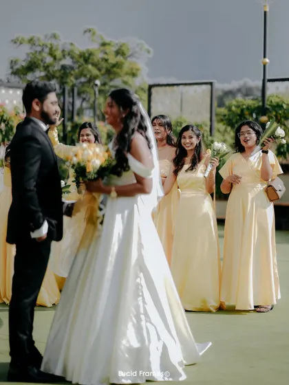 The groom sees his bride for the first time, a moment filled with laughter and emotion, with the bridesmaids looking on.