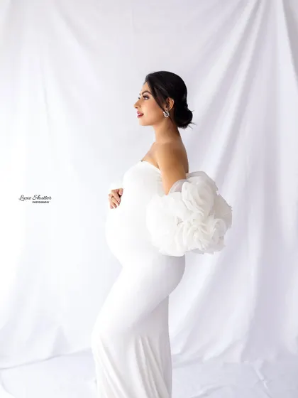 A classic profile shot is a must-have in any maternity gallery. It beautifully highlights the baby bump and the elegant lines of the gown, creating a timeless and graceful image.