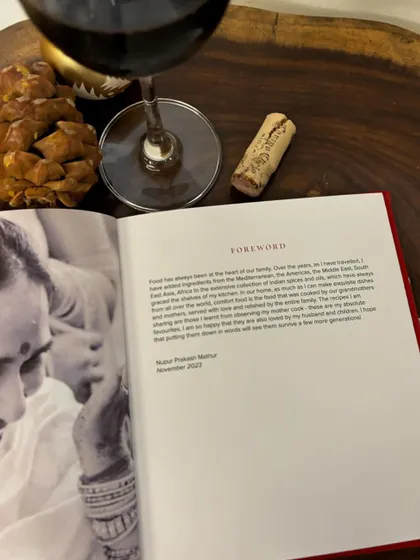 A look inside one of our bespoke family cookbooks, showing the foreword next to a cherished family photograph.