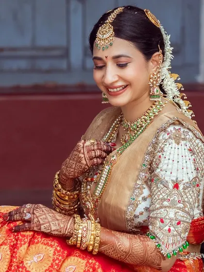 Manvita looking radiant in her cream-colored raw silk blouse, adorned with intricate hand embroidery.