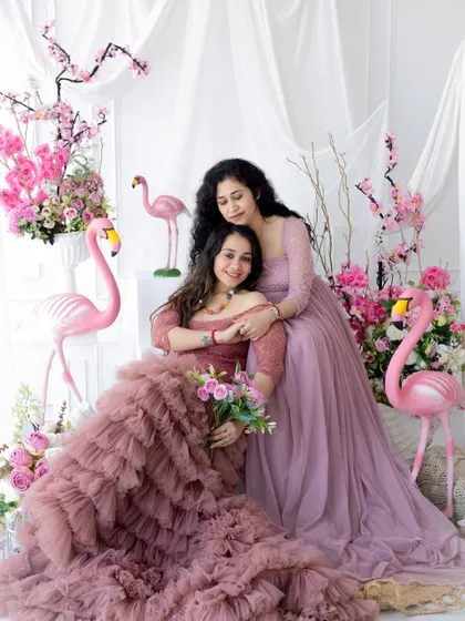 A beautiful portrait of a mother and daughter for our Mother's Day mini-session. The pink floral and flamingo theme creates a vibrant and loving atmosphere.