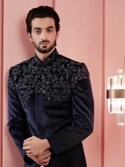 This shot captures the luxurious feel of the navy velvet jacket, perfect for a wedding reception or a black-tie event with an ethnic twist.