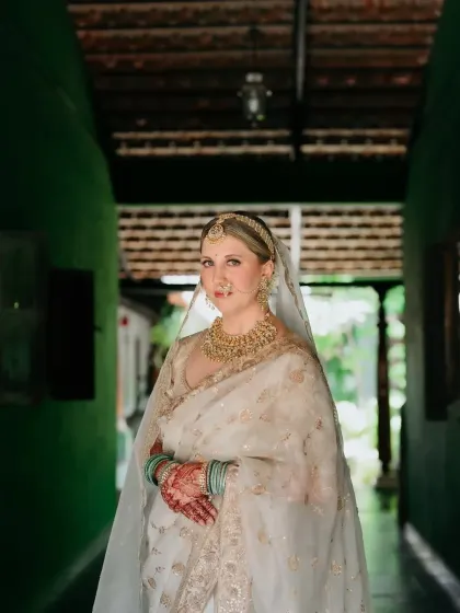A stunning bridal portrait where the rich henna stain on her hands adds a beautiful, traditional element to her elegant look.