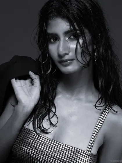 A black and white shot with the model looking over her shoulder, creating a classic pose.