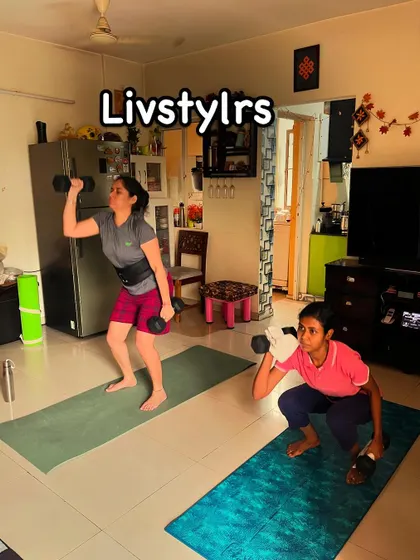 Two clients of different ages perform a squat with an overhead press, showing that strength training is beneficial for women at every stage of life.