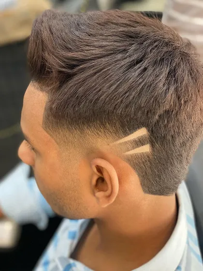 A close-up shot focusing on the precision of the hair tattoo. The two parallel lines create a simple but impactful geometric design within the fade.