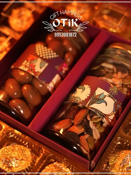 A close-up shot of the jars inside my Diwali chocolate box, one filled with chocolate-coated almonds and the other with a healthy mixed seed blend.