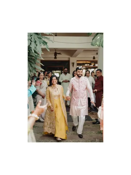 The groom's entrance with his mother, a happy and significant moment from the pre-wedding celebrations.