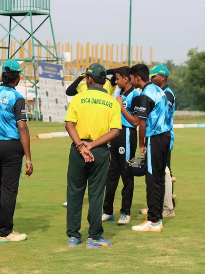 A coach gives a team talk during a break in a Dasara Cup match.