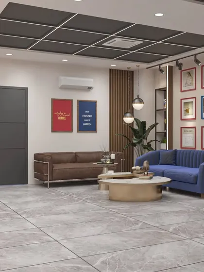 A comfortable and stylish office lounge area with a mix of blue and brown sofas, perfect for informal meetings or welcoming guests.
