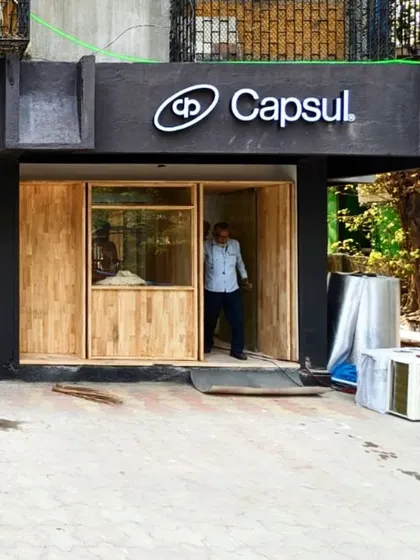 The facade during construction, with the wooden framework for the windows and entrance being installed. This shows the meticulous process of crafting the interactive storefront.