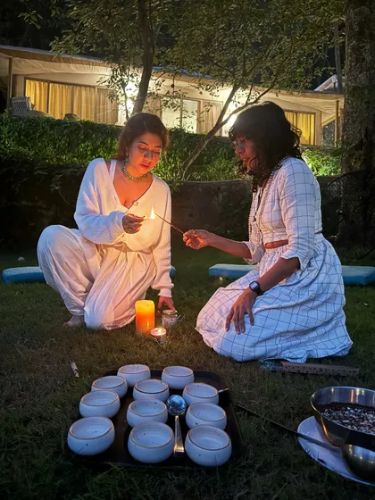 Lighting candles together for a full moon ritual. These shared practices help us reflect on our experiences and set intentions as a collective, strengthening our bonds.