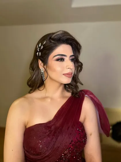 This side profile shows off the glamorous Hollywood waves and the sparkling hair accessories, which tie in perfectly with the elegant makeup.