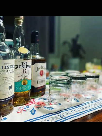 A selection of premium spirits ready for a home party. We can stock your bar with a variety of liquors, including single malt scotch like The Glenlivet and Talisker, to cater to all tastes.