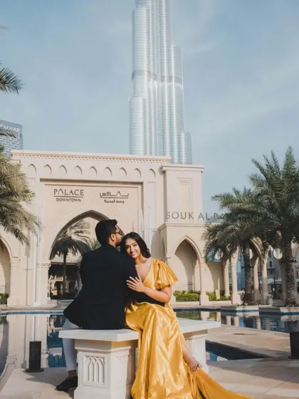A romantic moment captured in Dubai, featuring our mustard yellow trail gown. The dress adds a touch of glamour and elegance to this iconic location.