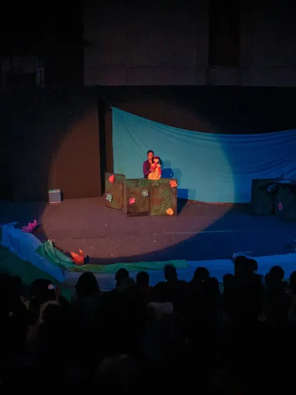 The amphitheatre is filled with an eager audience for 'Aisha's Journey'. Our outdoor performances create a unique and memorable atmosphere for families.