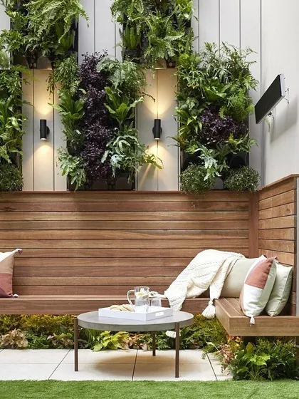 We can integrate greenery directly into your seating areas. Here, we used wall-mounted plant frames above a wooden bench to create a cozy and natural nook, with integrated lighting to highlight the foliage.